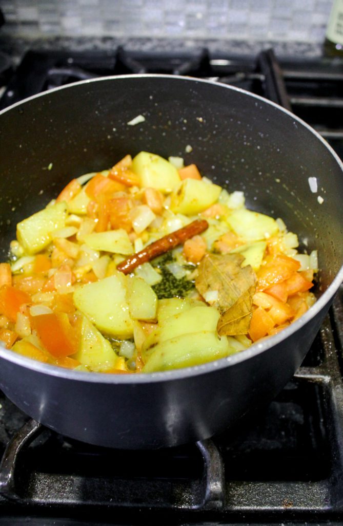 vegetable pulao aromatics and potato cooking in pot