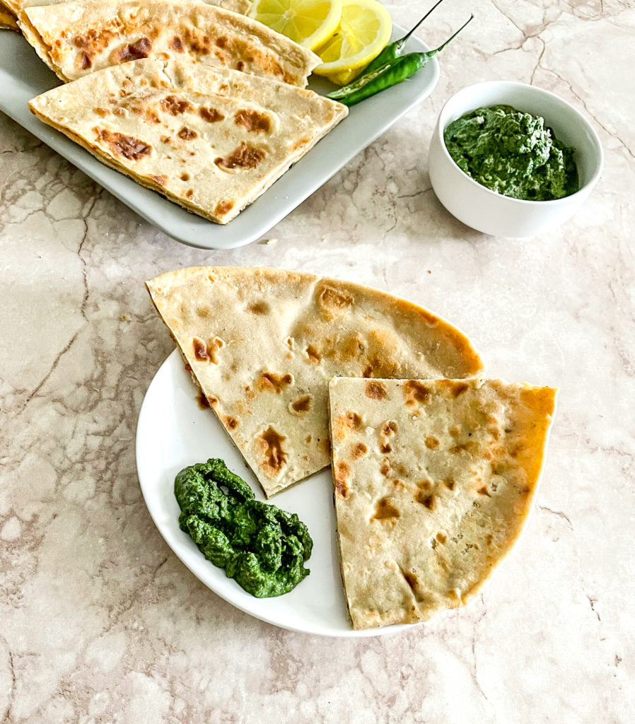 aloo paratha quarter a plate with green chutney