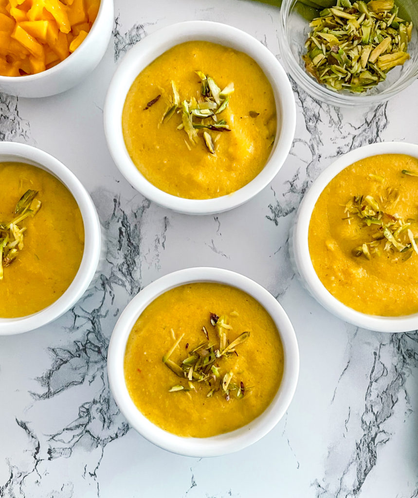 4 bowls of mango phirni garnished with pistachios