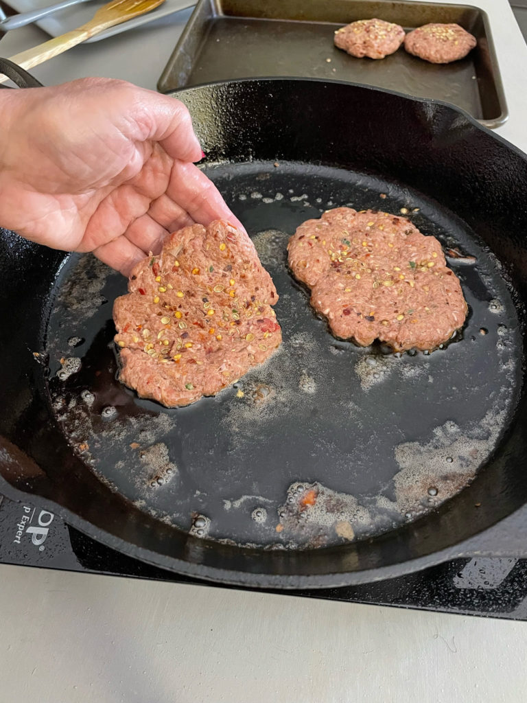 chapli kabab shallow fry on a cast iron pan