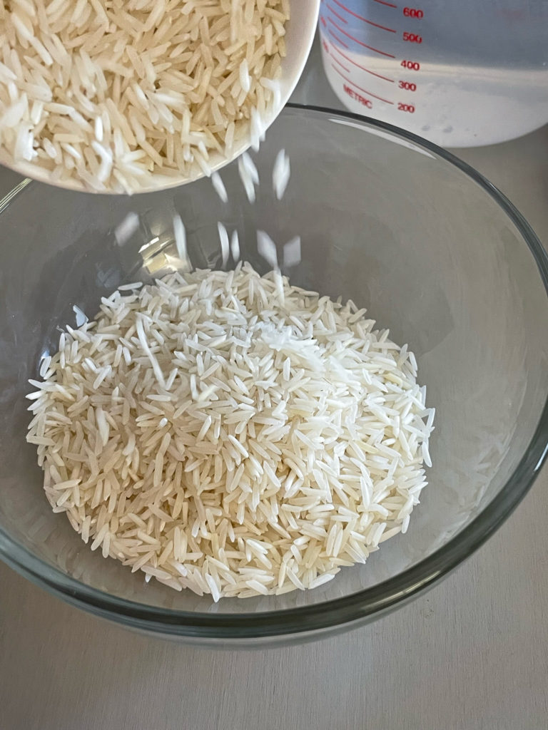 pouring basmati rice in a bowl for rajma chawal