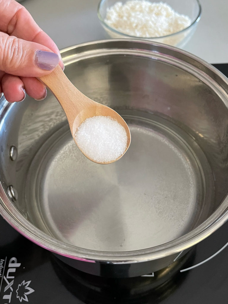 adding salt to a pot for rajma chawal