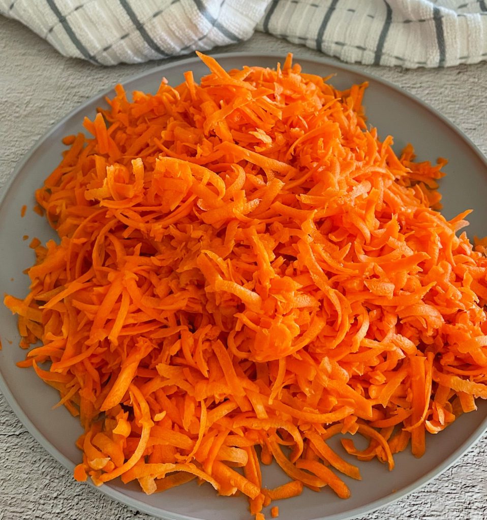 grated carrots on a plate for gajar ka halwa
