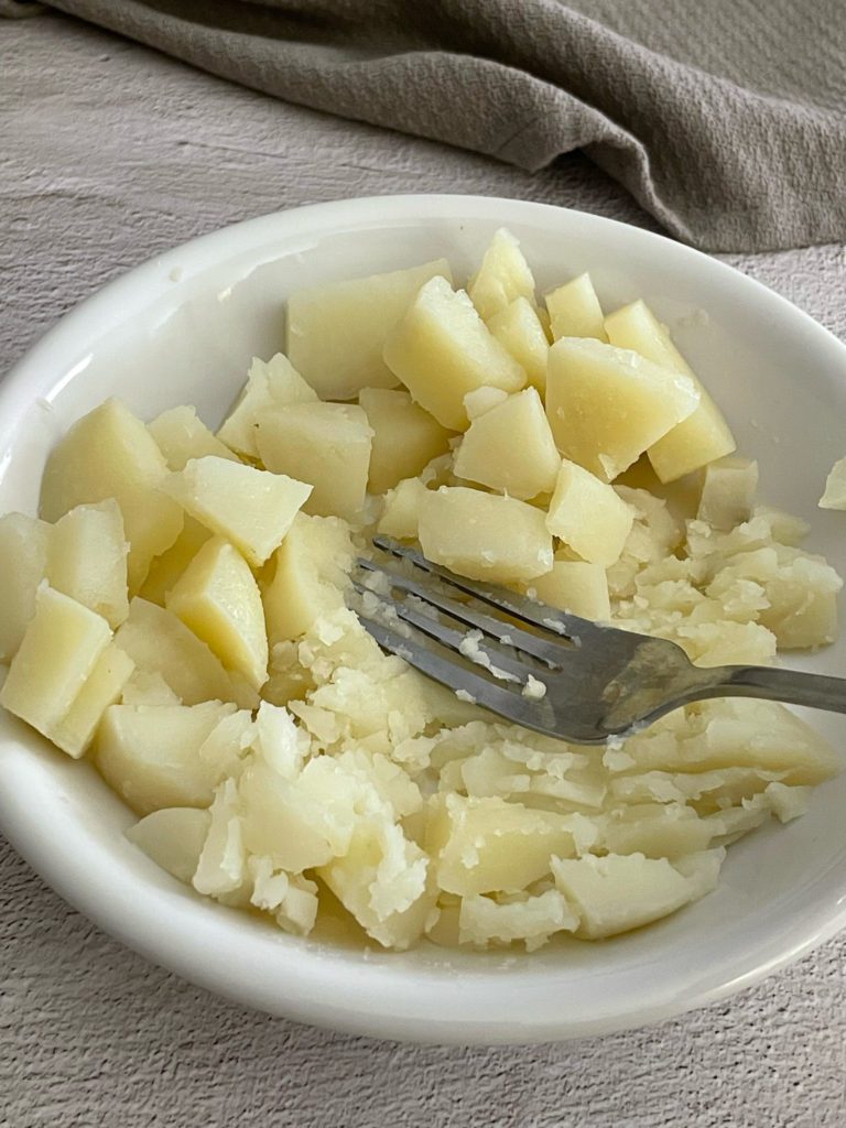 potatoes mashed with fork