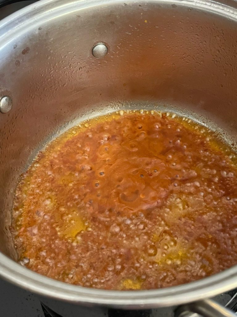 aromatics being cooked in pot.