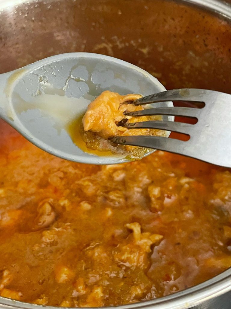 chicken on spoon poked with a fork