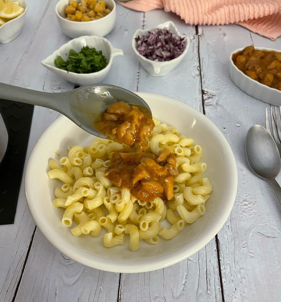 Burma saag added to top of macaroni pasta