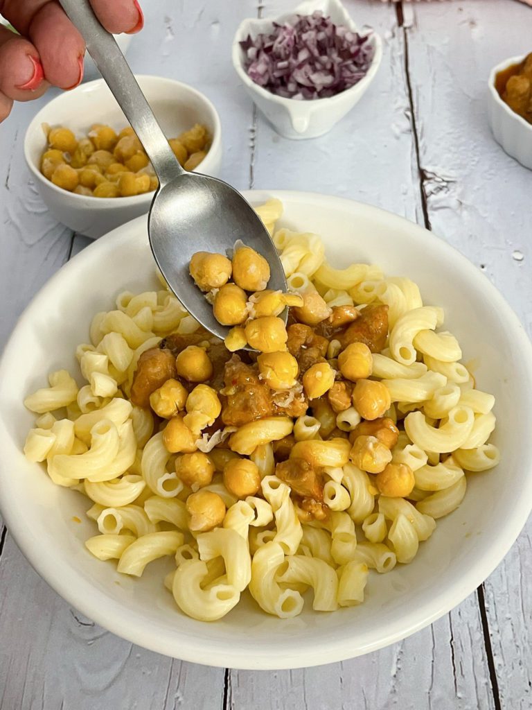 Chickpeas added to top of macaroni and meat curry