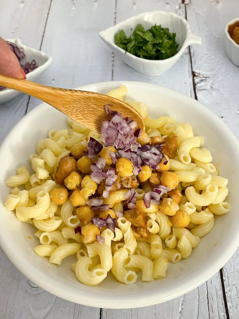 dish being topped with red onions